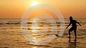 Silhouette of happy surf man surfing with long surf boards at sunset on tropical beach