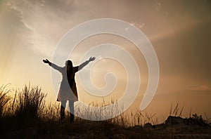 Silhouette of happy woman enjoying nature, enjoyment of nature and freedom