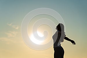 Silhouette of happy woman spreading arms and watching the mountain. Travel Lifestyle success concept adventure active vacations