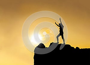 Silhouette - happy young girl on top of mountain