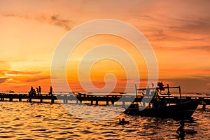 Silhouette of Harbor bridge and people during sunset at Bang Phra Beach,sriracha choburi,thailand