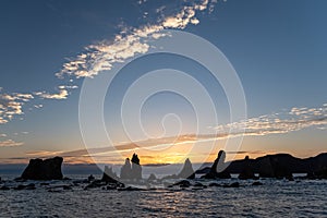 Silhouette of Hashigui-iwa Rocks at dawn photo