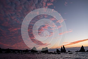 Silhouette of Hashigui-iwa Rocks and purple clouds at dawn photo