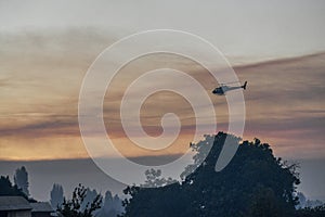 Silhouette of the helicopter that fights forest fires.