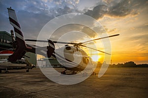 silhouette of helicopter in the parking lot or runway with sunri