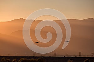 Silhouette of helicopter with sunset.