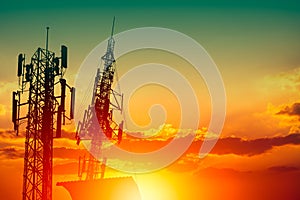 Silhouette of high frequency 5G station communication tower or 4G network telephone cellsite with dusk sunset sky with space for