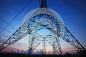 Silhouette of high voltage electric pole against beautiful dusky