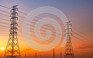 Silhouette high voltage electric pylon and electrical wire with purple and red sunset sky. Electricity poles at sunset. Power and