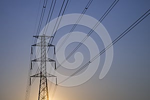 Silhouette High voltage electricity pylon sunset