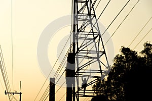 Silhouette high voltage pole on sky sunset background.