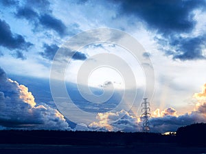 Silhouette of high voltage post and High-voltage tower