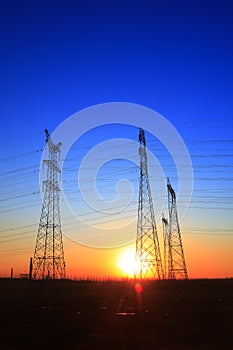 The silhouette of high voltage towers