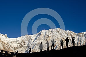 silhouette of hikers in front of Annapurna mountain Nepal