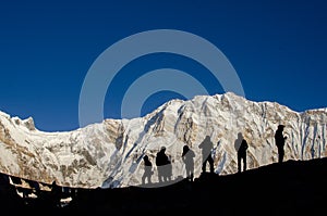 silhouette of hikers in front of Annapurna mountain Nepal