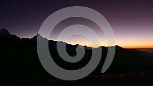 Silhouette of Himalayan mountain ranges and hills as the sun rises, viewed from the summit of Poon Hill