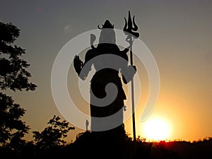 Silhouette of Hindu god Shiva at sunset