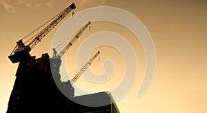 Silhouette Hoisting cranes machine for move materials at building construction site