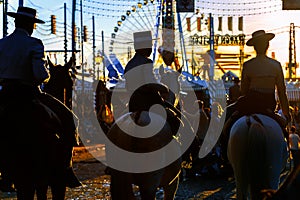 Silhouette of Horse riders at sunset. Seville`s April Fair.