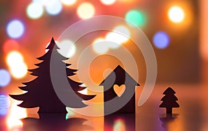 Silhouette of house with hole in form of heart and Christmas trees with garland lights on backgrounds