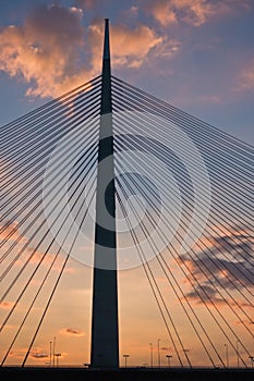 Silhouette of a huge cable bridge over Sava river at sunset in Belgrade