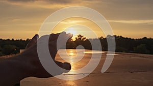 A silhouette of a human hand reaching out