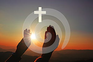 Silhouette of human hands palm up praying and worship of cross, eucharist therapy bless god helping, belief, forgiveness, freedom