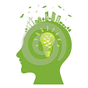 Silhouette of a human head with electric lamp inside. Think green. Electric lamp with a blossoming tree. Green city with renewable