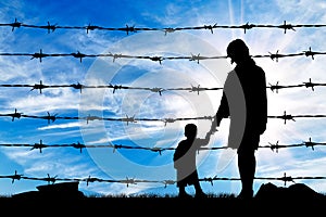 Silhouette of hungry refugees mother and child photo