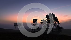 Silhouette of a hunting tower at dawn