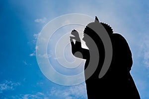 silhouette image of Buddha statue.