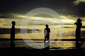 Silhouette image concept young kids playing at the sandy beach