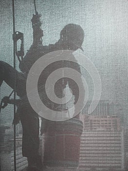 Silhouette images of man cleaning the window office building