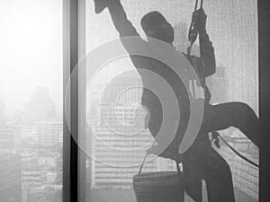 Silhouette images of man cleaning the window office building