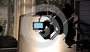 Silhouette images of video camera in tv commercial studio production