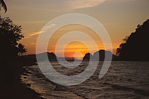 Silhouette of island on sunset on Philippines island, El Nido. Scenic evening landscape on sunset. Tropical coast in night dusk.