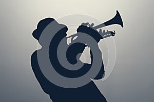 silhouette of a jazz man playing trumpet