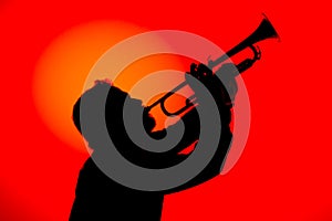 Silhouette of a jazz musician  playing trumpet, isolated in red background. Jazz music concept