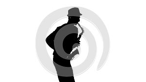 Silhouette jazzman performs solo on saxophone in a slow motion