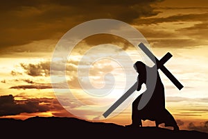 Silhouette of Jesus carry his cross