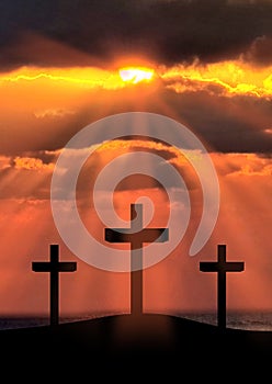 Silhouette of Jesus Christ crucifixion on cross on Good Friday Easter over heaven sunrise -Three Crosses On Hill vertical