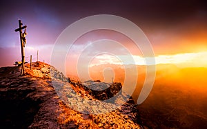 Silhouette Jesus Christ crucifixion on cross in Dolomites mountain