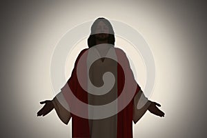 Silhouette of Jesus Christ with outstretched arms on color background