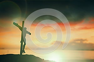 Silhouette of Jesus with Cross over sunset concept for religion, worship, Christmas, Easter, Redeemer Thanksgiving prayer and