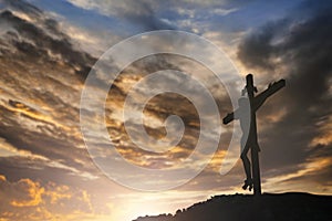 Silhouette of Jesus with Cross over sunset concept for religion, worship, Christmas, Easter, Redeemer Thanksgiving prayer and