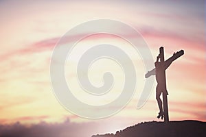 Silhouette of Jesus with Cross over sunset concept for religion, worship, Christmas, Easter, Redeemer Thanksgiving prayer and