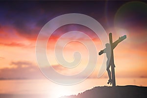 Silhouette of Jesus with Cross over sunset concept for religion, worship, Christmas, Easter, Redeemer Thanksgiving prayer and
