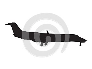 silhouette of jet plane coming in to land with the landing gear released