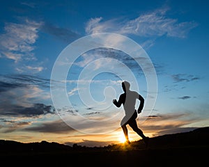 Silhouette of a jogger in sunset