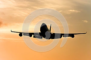 Silhouette of jumbo jet in flight.